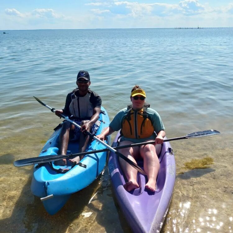 Couple kayaking in the Chesapeake Bay at Point Lookout State Park, Maryland, enjoying a summer outdoor adventure.