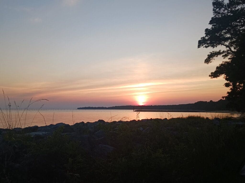 Sunset over the Chesapeake Bay at Point Lookout State Park in Maryland, highlighting the park’s peaceful shoreline views.