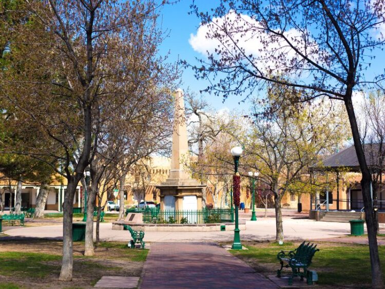 Mindfulness and culture in Santa Fe at the historic Plaza with adobe buildings and Native American artisans selling handmade jewelry.