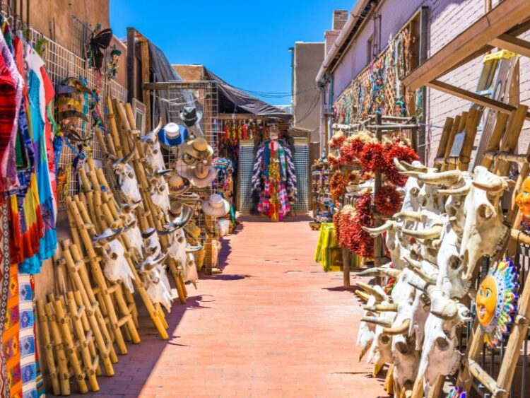 Santa Fe market filled with handmade crafts, jewelry, decorated skulls, and vibrant cultural art displays.