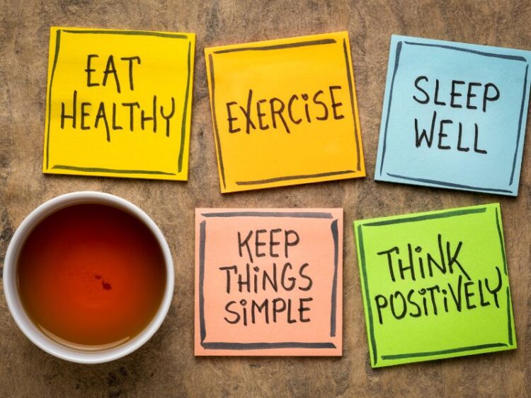 Self-care reminders on sticky notes: eat healthy, exercise, sleep well, keep things simple, think positively.