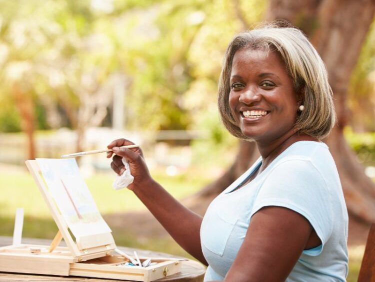 Creative ritual for intentional living, woman painting outdoors