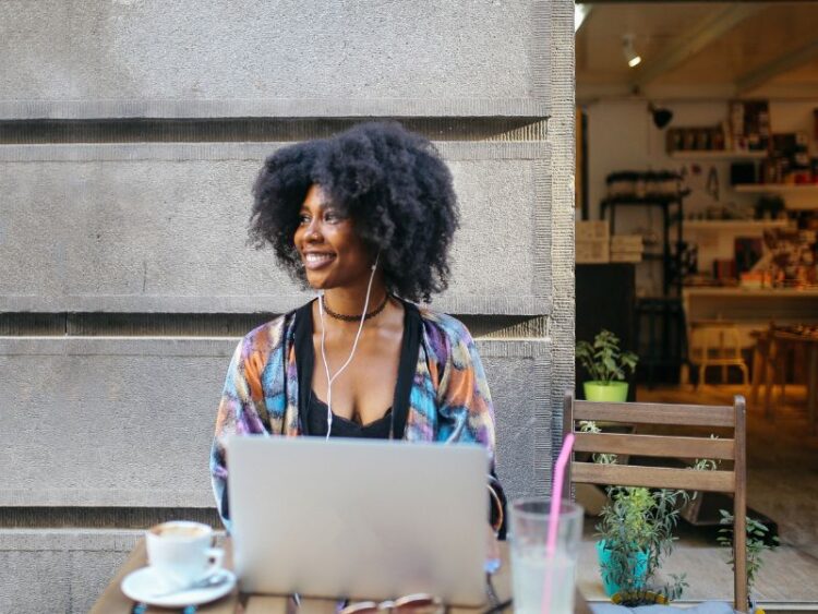 Traveler using a laptop to search for flight deals and loyalty rewards online.