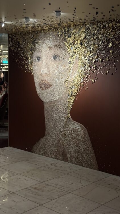 Decorative art wall featuring woman’s face aboard cruise ship
