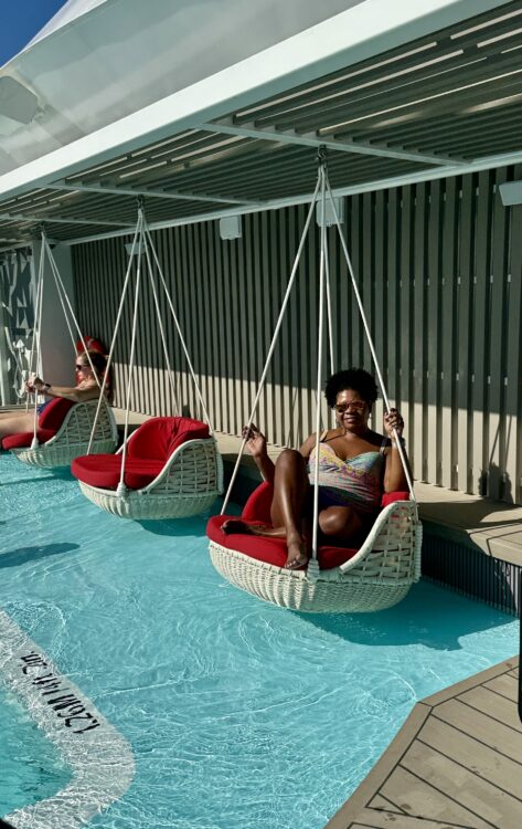 Mindful travel moment, woman enjoying swing chair by cruise pool
