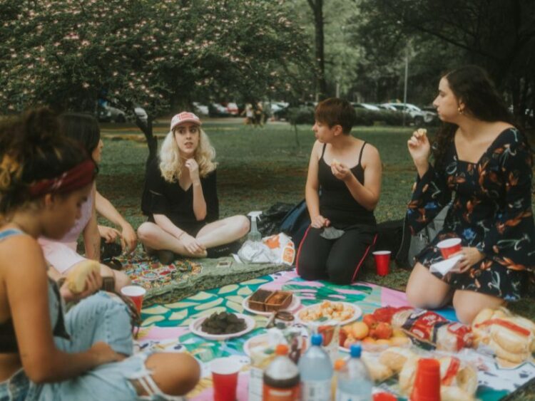 Intentional living through connection, friends sharing picnic together