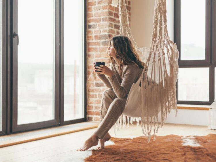 Mindful living moment, woman enjoying coffee in cozy home sanctuary