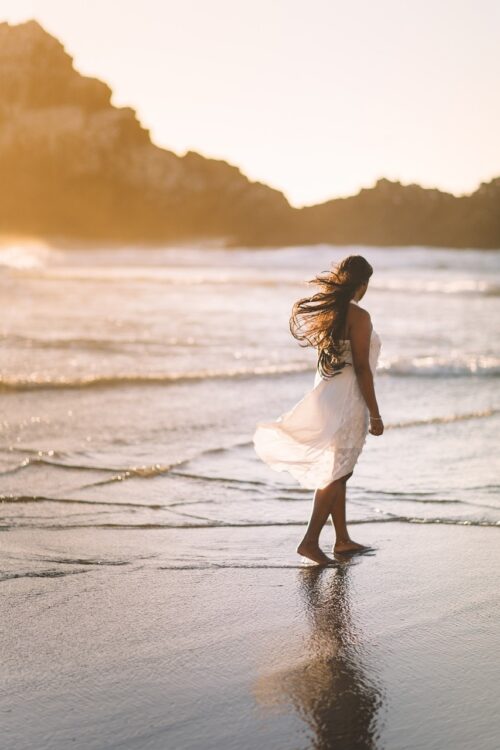 Traveler walking, beach, sea, coast, shore, ocean, water, girl, nature, alone, waves, sunrise enjoying presence and calm without financial worry