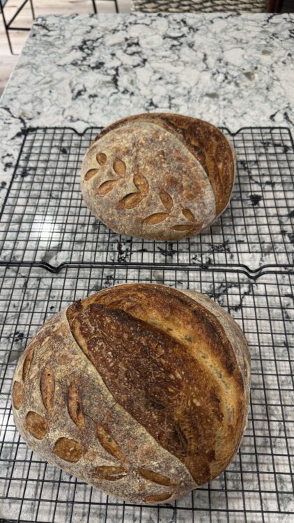 2 Loaves on cooling racks: mindful sourdough bread recipe loaf cooling on rack after baking
