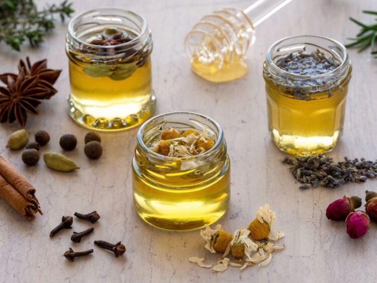 4 Jars of herbal honey infused with chamomile and lavender—natural ingredients used in mindful mocktails and cocktails for relaxation.