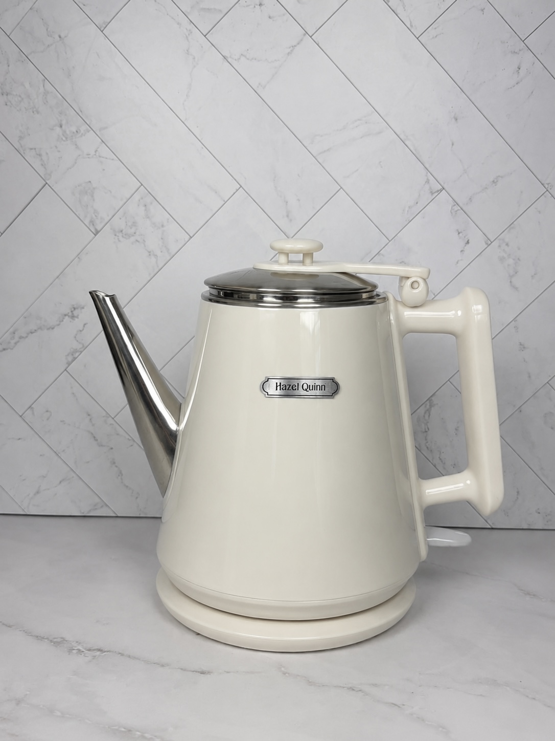 Hazel Quinn cream electric gooseneck kettle for pour-over coffee and tea on a marble countertop.