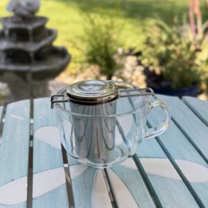 Stainless steel tea infuser with double-wall glass mug for loose-leaf tea, perfect for creating a comforting tea ritual at home.
