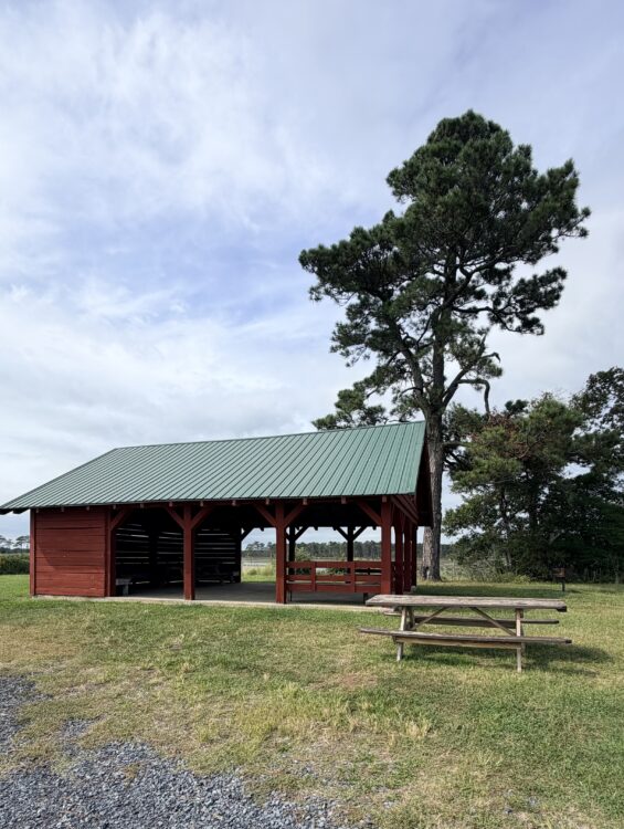 Red picnic shelter with tables at Assawoman Wildlife Area in Delaware.